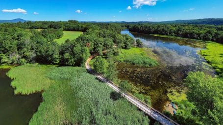 aerial summer view of the boardwalk trail at Bluffside Farm and Scotts Cove in Newport