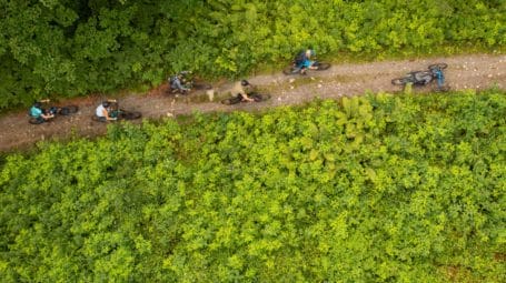 Adrea Morgante Fund: Aerial view of people riding bikes along a forest path in Hinesburg