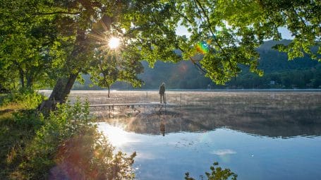 man fishing at sunrise on Lake Saint Catherine