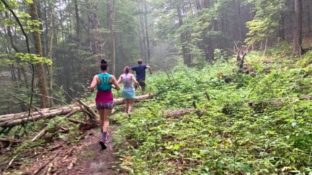 Runners on a wooded trail in East montpelier