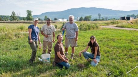 group of people digging farm soil for healthy soil study at Harrison's Homegrown dairy farm in Vermont