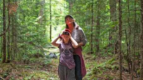 Woman and child on trail in woods