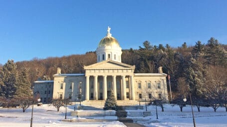 Golden-domed building with pillared facade. Vermont State House.
