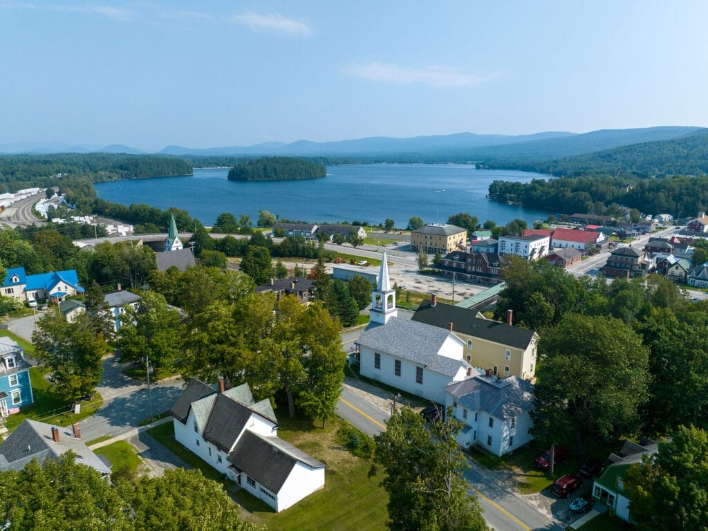 aerial photo of small New England town with large lake - Island Pond in Brighton Vermont 